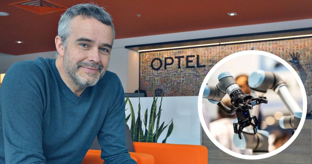A man smiling while seated in an office with the OPTEL logo in the background, alongside an image of a robotic arm.