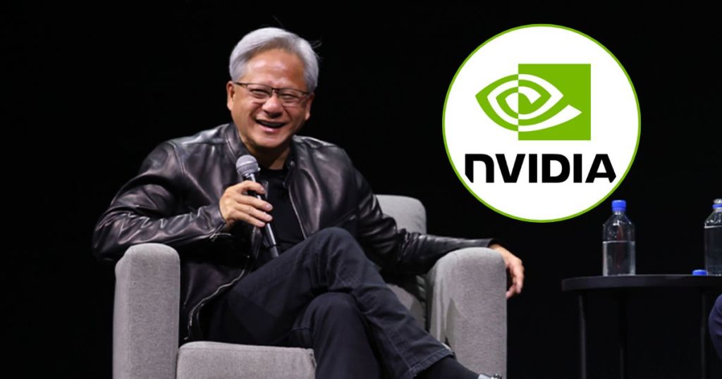 A smiling man wearing glasses and a black leather jacket sits on a stage, holding a microphone, with an NVIDIA logo graphic in the background.