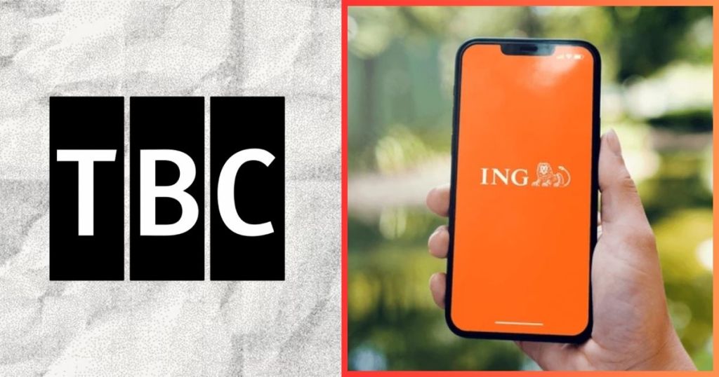 A hand holding a smartphone displaying the ING logo on a bright orange background, with blurred greenery in the background.