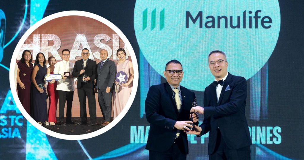 A group of people poses together on stage at an awards ceremony, holding trophies and awards, with a 'Manulife' logo displayed in the background.