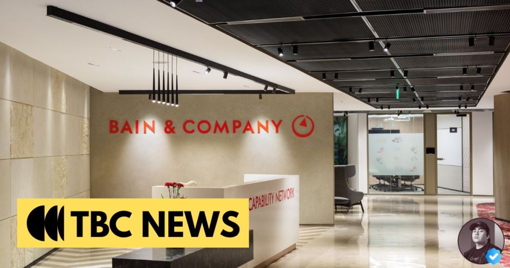 Lobby of Bain & Company office featuring a reception desk and modern interior design.