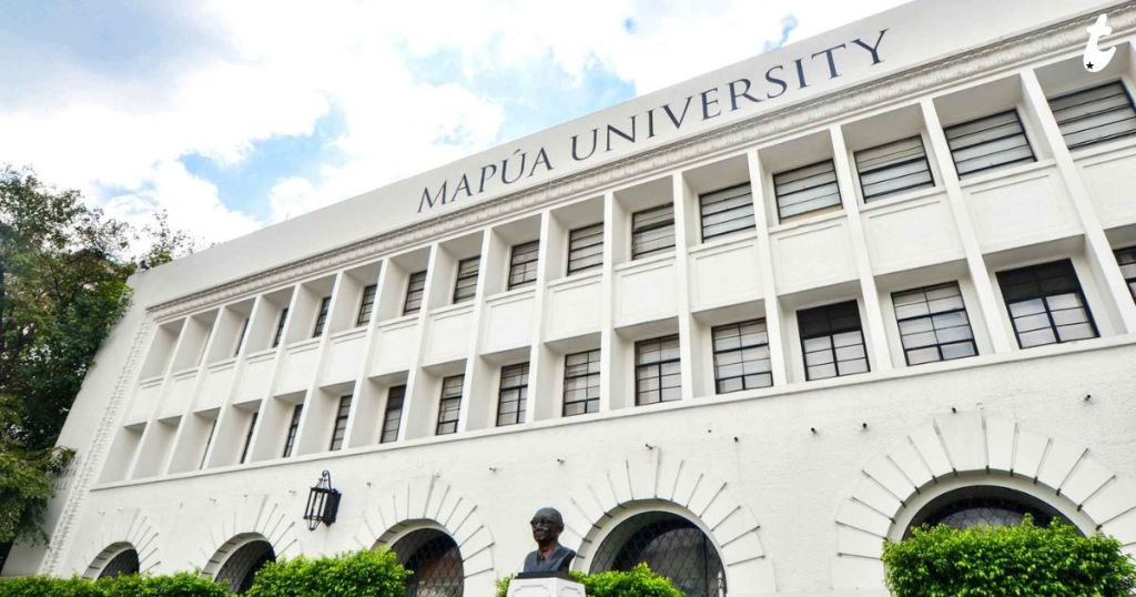 Exterior view of Mapúa University building with a statue in front and clear blue sky.