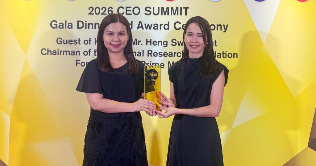Two women standing together at the 2026 CEO Summit Gala Dinner and Award Ceremony, holding an award trophy against a yellow backdrop with event details.
